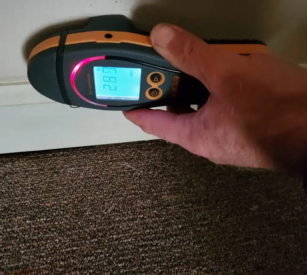 Moisture detection at baseboard during Storm Damage Restoration in Brownfields